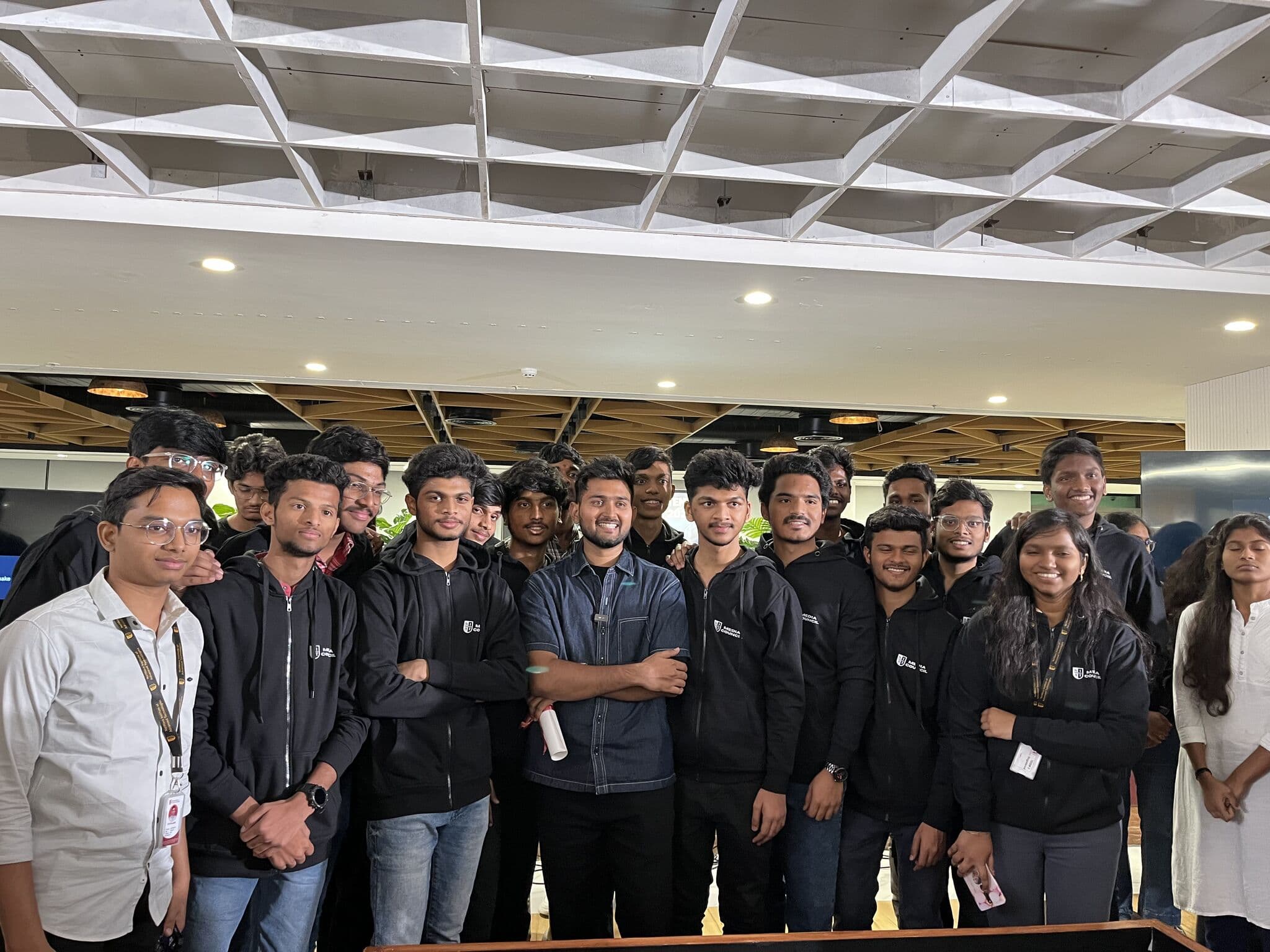 Sri Pavan Tej Balam with the NIAT Media Council team in matching hoodies on campus